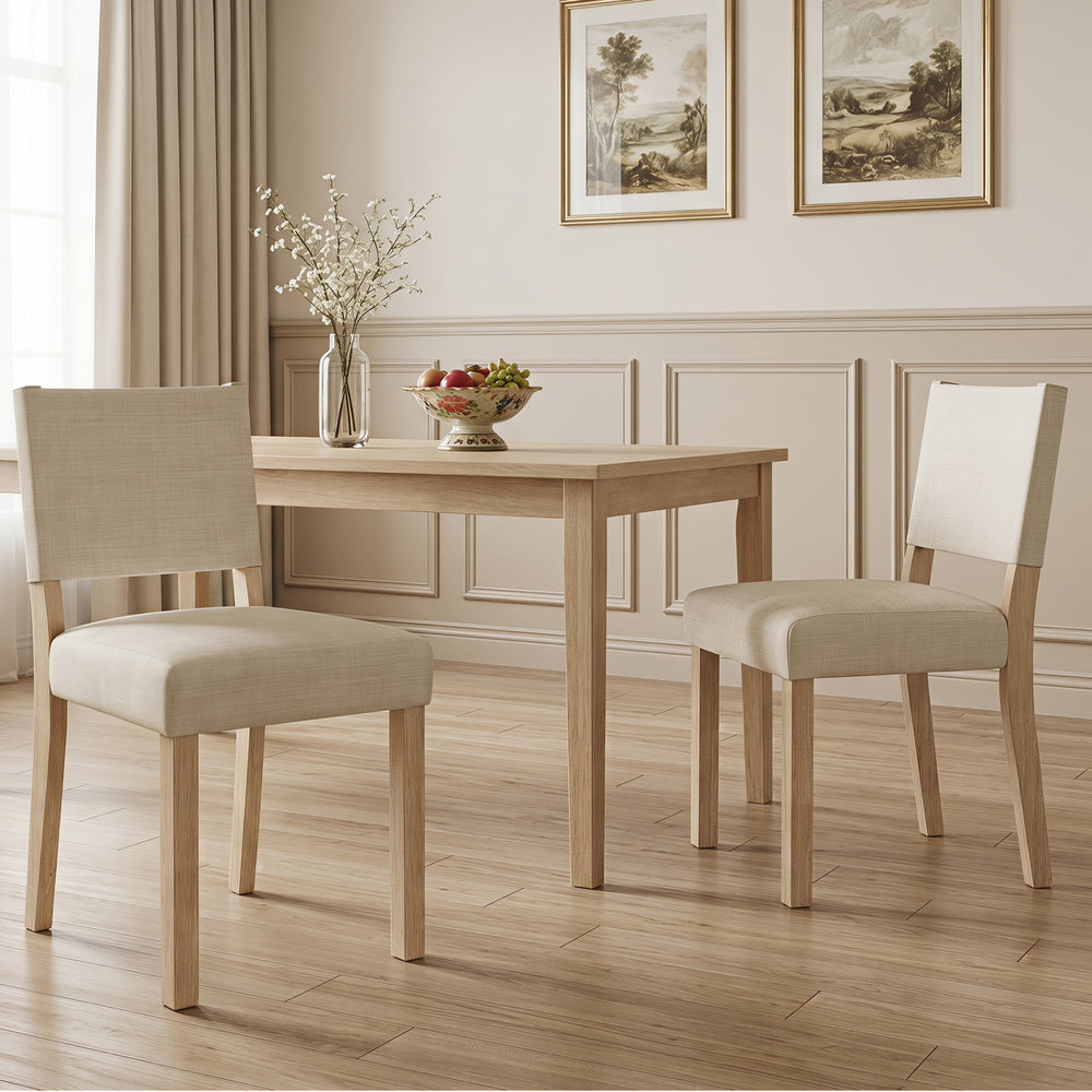 Upholstered dining chairs in beige with solid rubber wood legs, offering comfort and rustic style for dining rooms.
