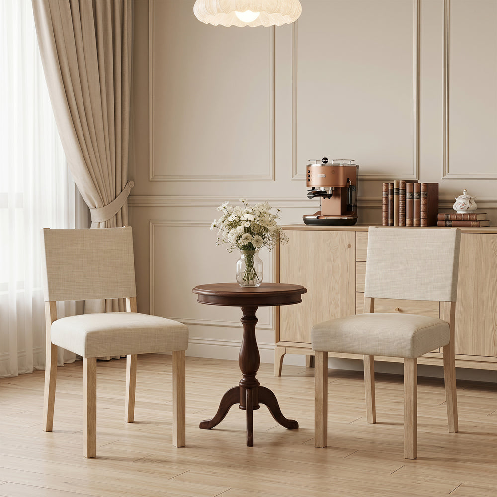 Upholstered dining chairs with solid rubber wood legs in beige, featuring ergonomic backrests for comfortable dining.