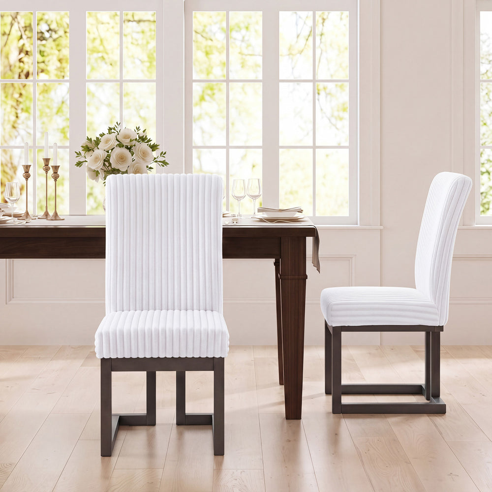 Set of 2 white upholstered dining chairs with rubber wood legs and padded seats, perfect for modern dining rooms.