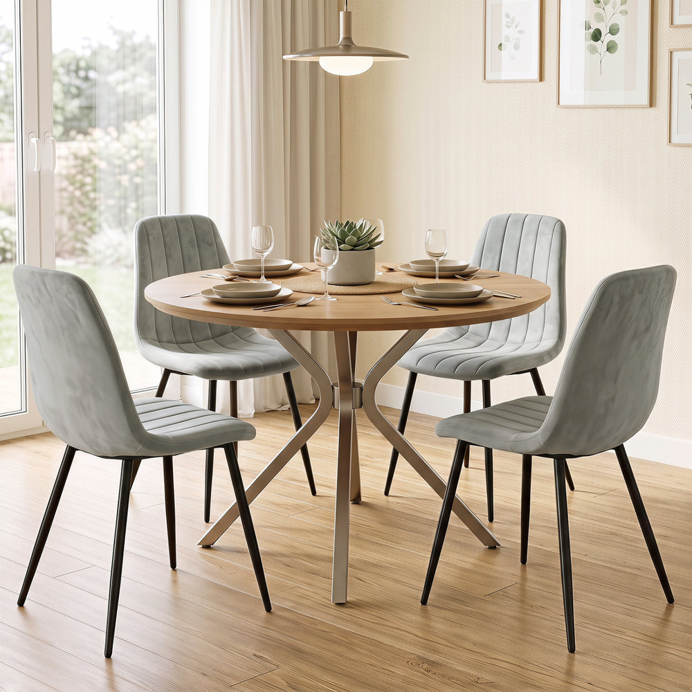 Gray upholstered dining chairs set of four with sturdy metal legs and curved backrests, perfect for modern dining spaces.