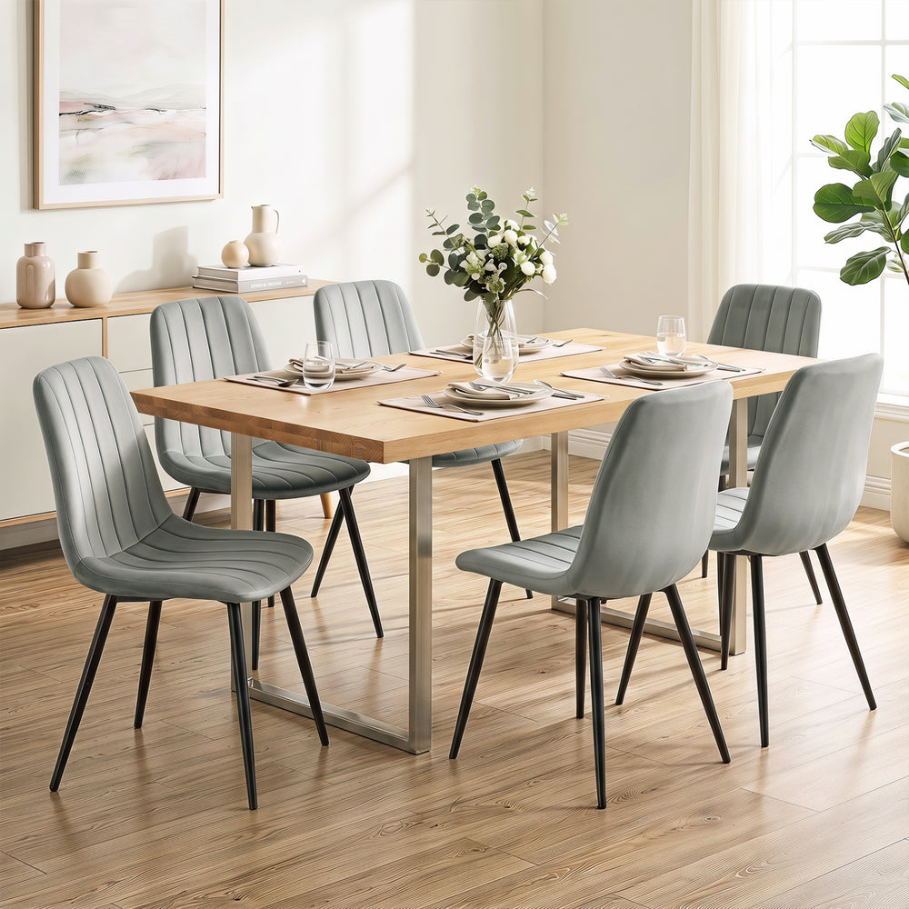 Gray upholstered dining chairs with sturdy metal legs and curved backrest, perfect for dining rooms and kitchens.