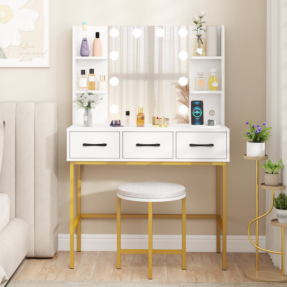 Vanity desk with illuminated mirror, gold accents, and cushioned stool, featuring ample storage for makeup and beauty.