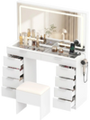 Vanity desk in white features adjustable lights, 10 drawers, a tempered glass top, and a matching cushioned stool.