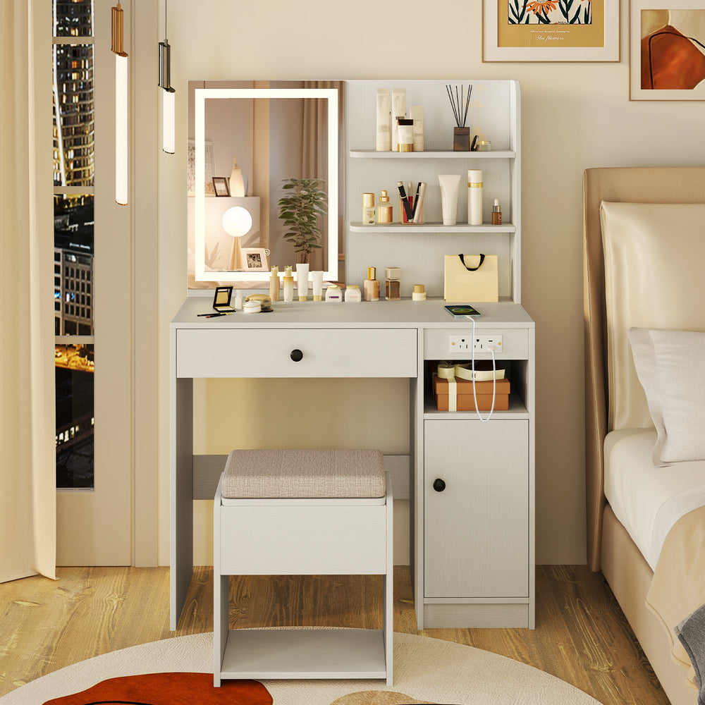Vanity desk in white with mirror and lights, featuring open shelves, drawer, and cushioned stool for organized beauty.