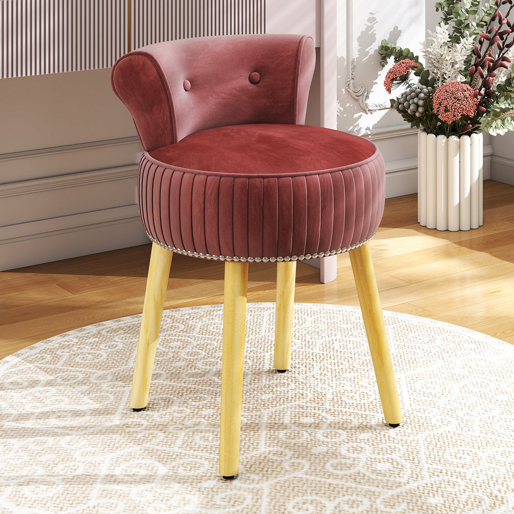 Velvet vanity chair in pink with tufted low back and solid wood legs, perfect for elegant dressing areas.