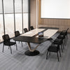 Set of two black office guest chairs with ergonomic mesh backrest, ideal for conference rooms and waiting areas.