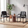 Side view of a black leather office reception chair with cushioned seat and ergonomic backrest, ideal for comfort in.