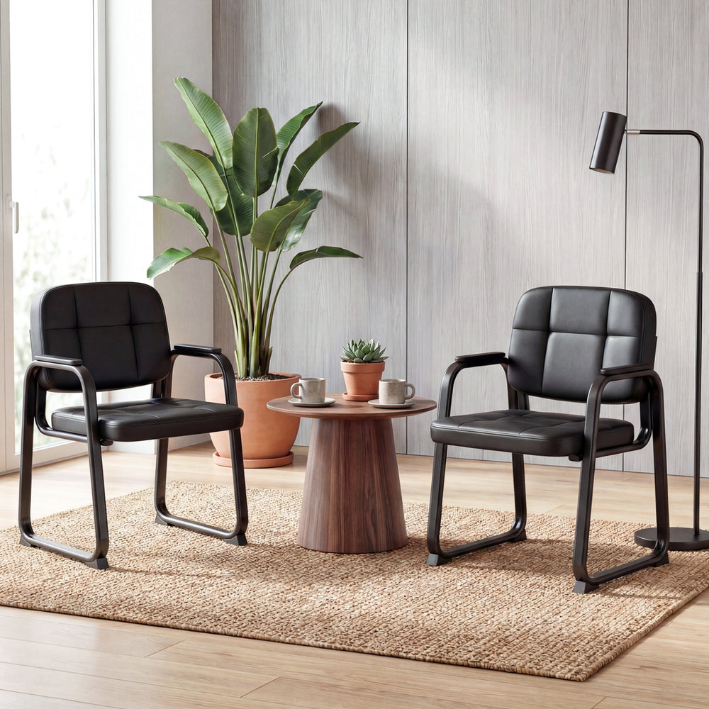 Side view of a black leather office reception chair with cushioned seat and ergonomic backrest, ideal for comfort in.