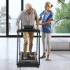 Senior using a 2.5 HP walking treadmill with extended handrails, featuring an LED display and safety key for secure.