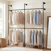 Wall-mounted black pipe clothing rack with four hanging rods, featuring a double-tier design for organized storage.