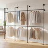 Wall-mounted black pipe clothing rack with 6 hanging rods, designed for organizing coats and shirts in small spaces.