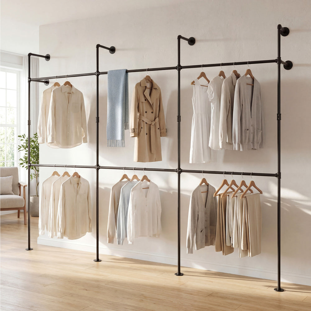Wall-mounted black pipe clothing rack with 6 hanging rods, designed for organizing coats and shirts in small spaces.