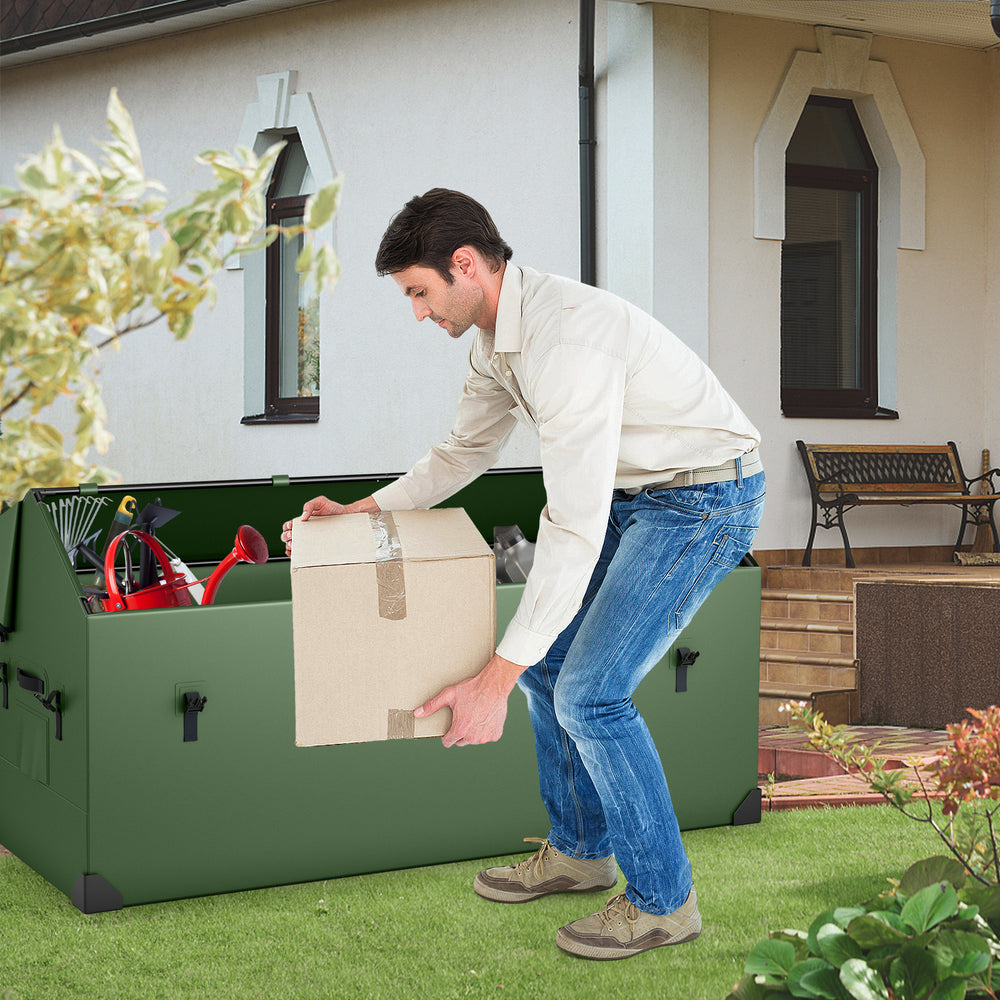 Man lifting a box from the waterproof outdoor storage box with ventilated window, ideal for organizing gardening tools.