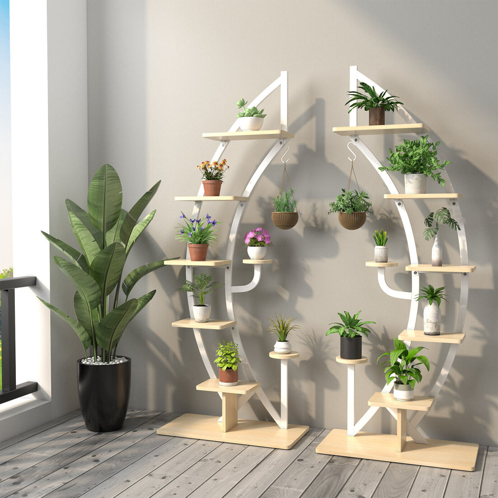 6-tier white metal plant stand with a unique curved shape, featuring multiple shelves for displaying various potted.