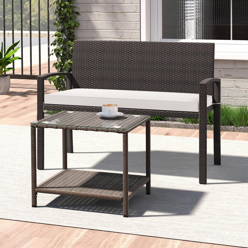 Wicker 2-seat bench with soft cushion and metal frame, ideal for outdoor patios and gardens.