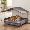 Wicker dog house with canopy in gray, featuring a raised bottom and removable cushion for indoor or outdoor pet comfort.