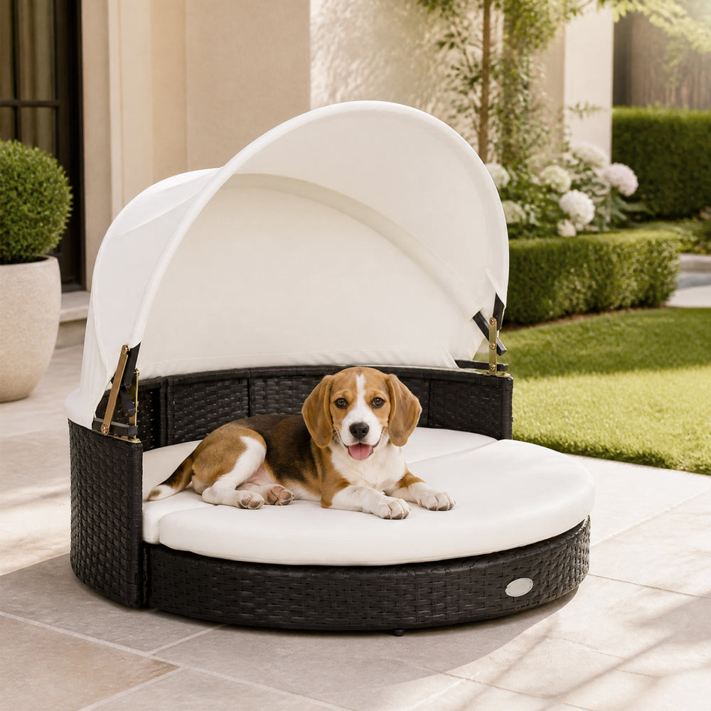 Wicker dog house with retractable canopy and protective cushion, designed for stylish outdoor lounging and comfort.