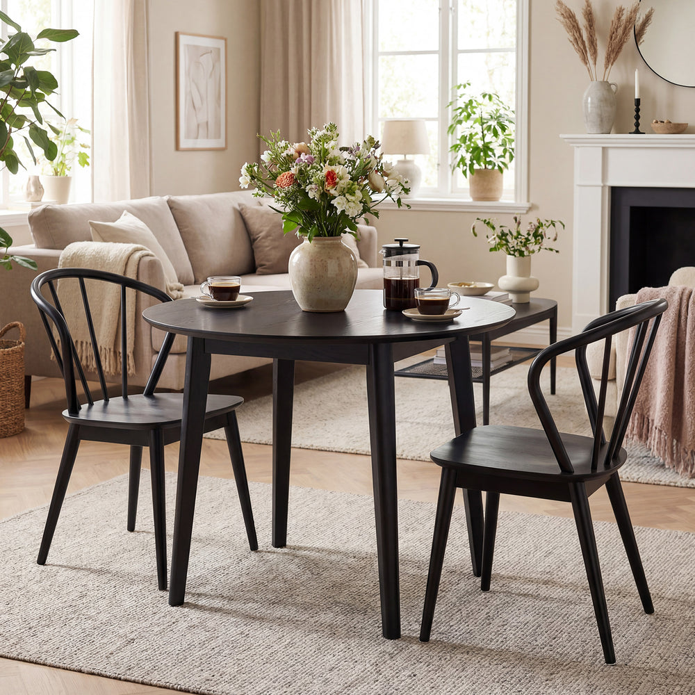 Set of 4 black Windsor dining chairs with spindle backrest, featuring rubber wood construction for stability and.