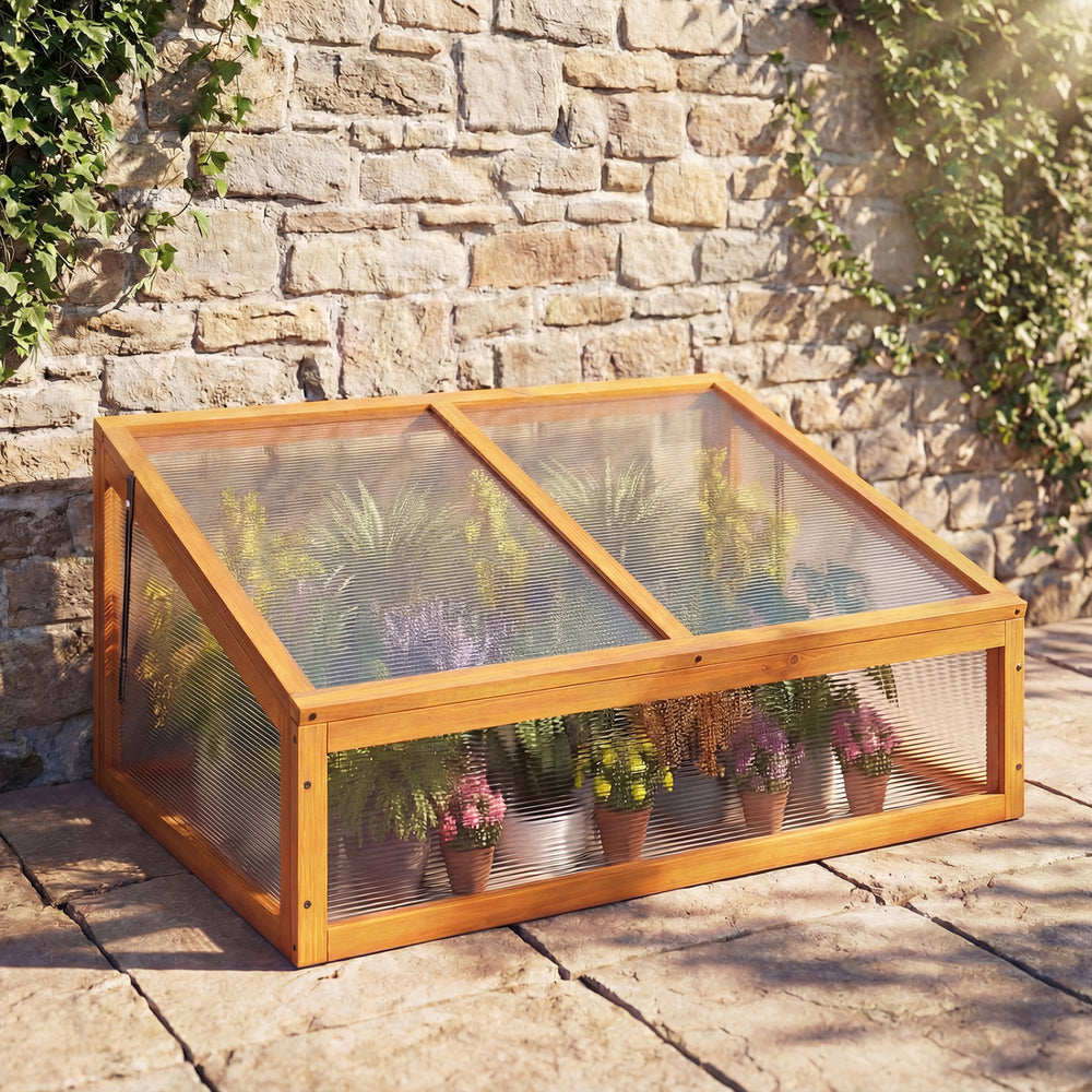 Wood cold frame greenhouse with transparent flip-top roof, made of sturdy fir wood, for protecting plants outdoors.