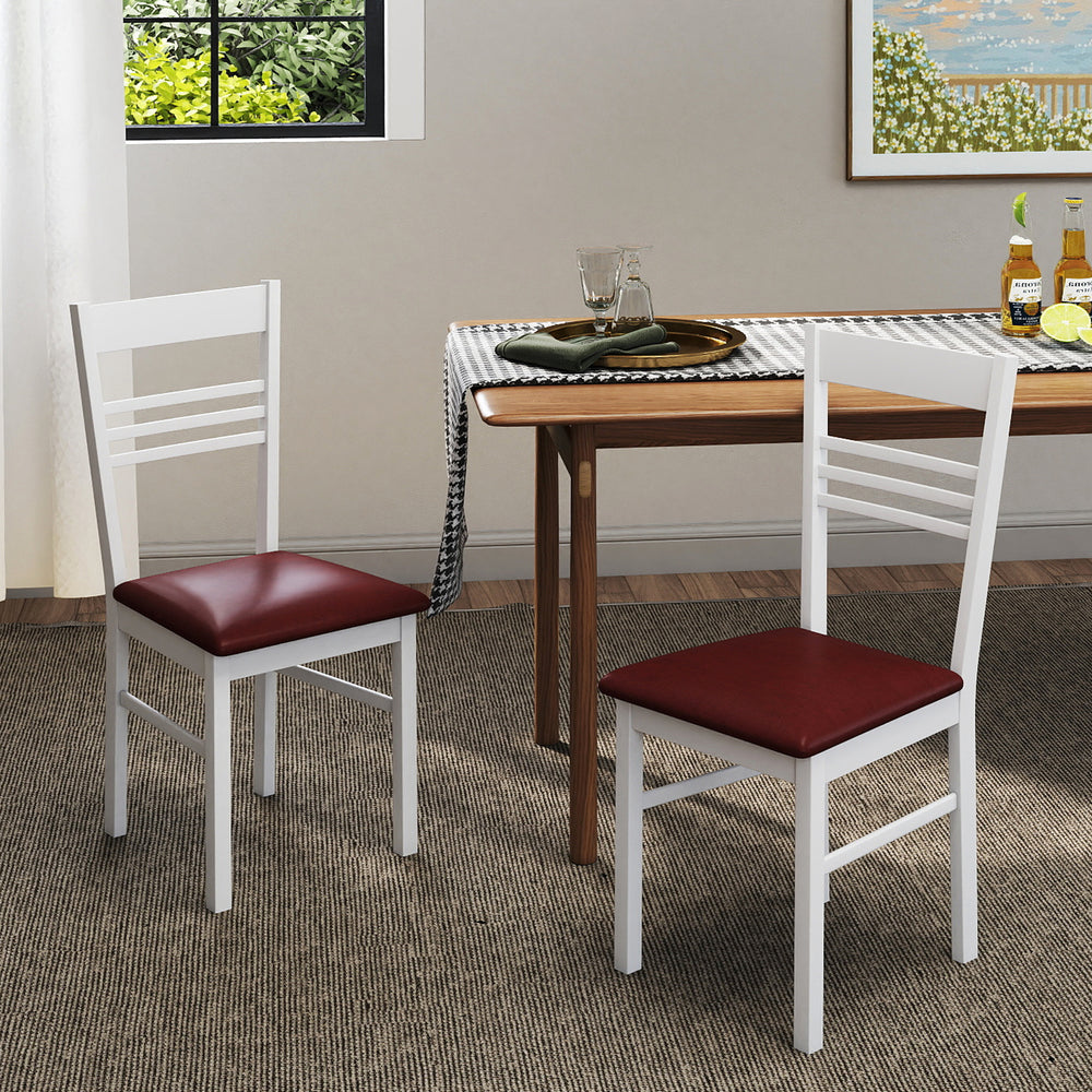 Set of 2 white wood dining chairs with rubber wood frame and red upholstered seats, ideal for kitchen or dining room.