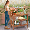 Wooden outdoor garden potting workstation with open shelves, perfect for plant care on patio or backyard.