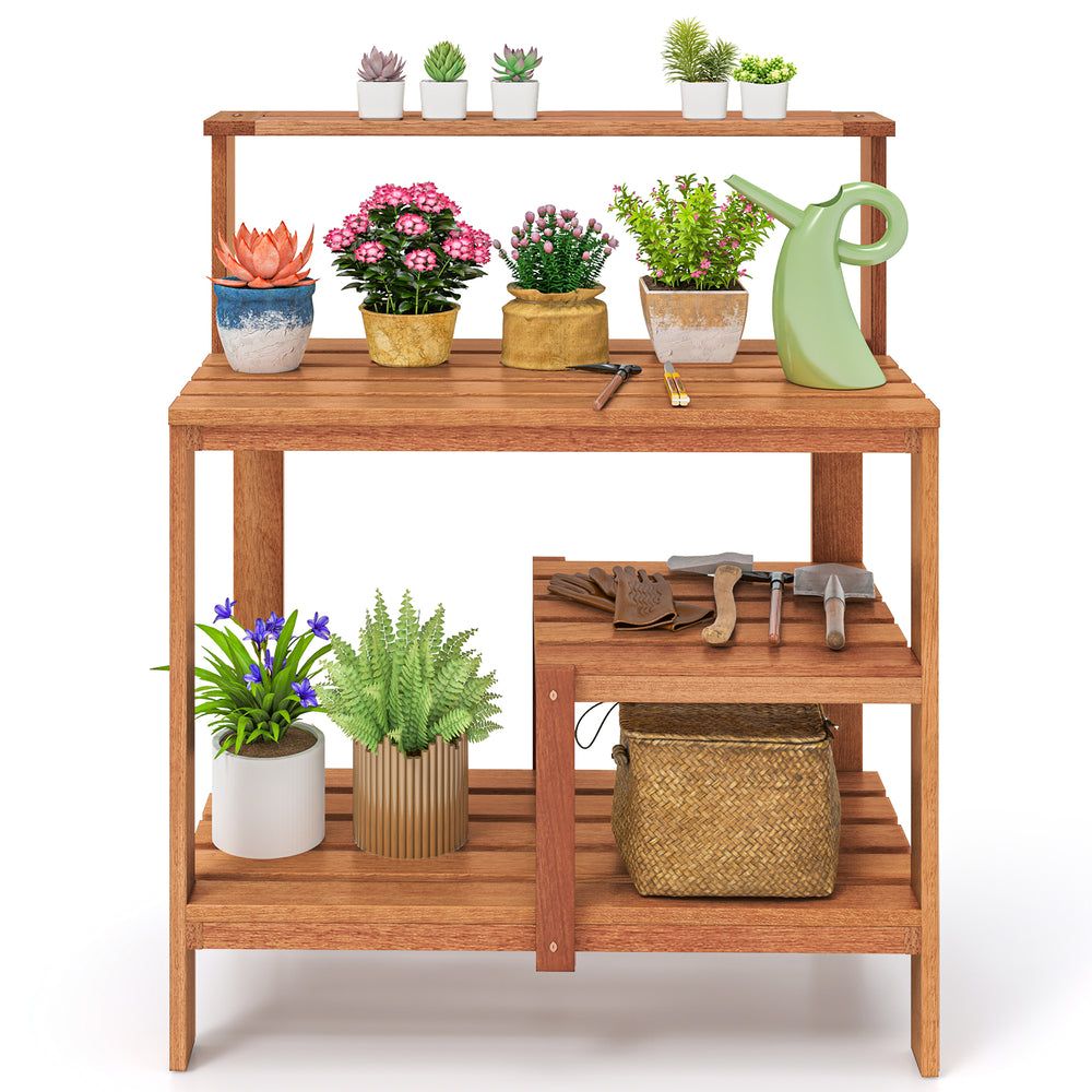 Wooden outdoor garden potting workstation with open shelves, featuring plants and tools, ideal for patio and backyard.