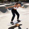 Wooden balancing board with cork roller, designed for enhancing balance and core strength during various sports.