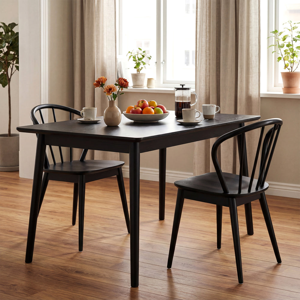 Black wooden dining chair set of 2 with high spindle backs, featuring wide seats for comfort in a cozy dining setting.