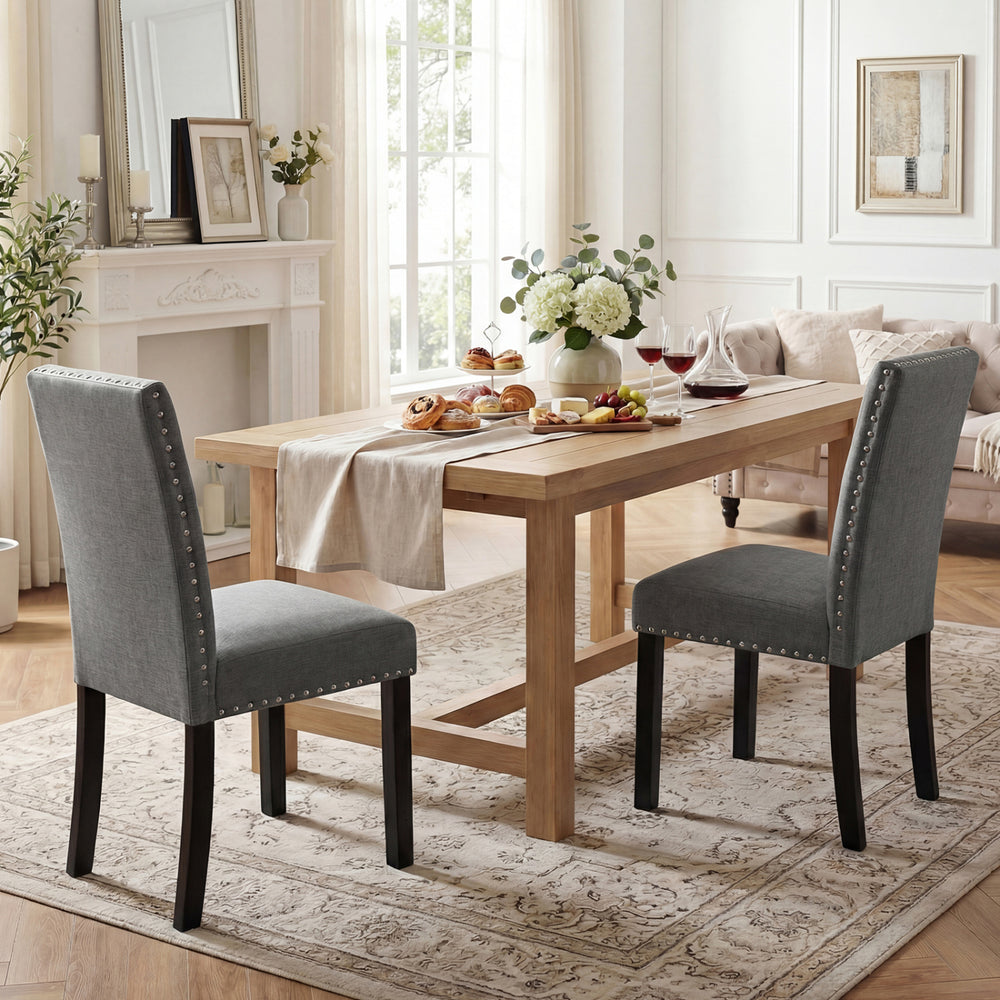 Set of 2 wooden dining chairs with soft cushions and bent wood legs, perfect for home dining or cafe settings.
