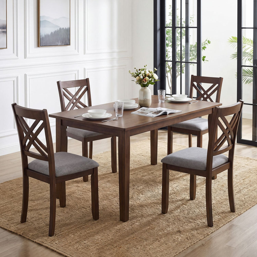 Brown wooden dining table set with four ergonomic chairs featuring fabric padded seats and a sturdy rubber wood frame.