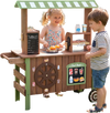 Wooden grocery store playset for kids featuring a hot dog grill, coffee maker, and large wheels for easy movement.