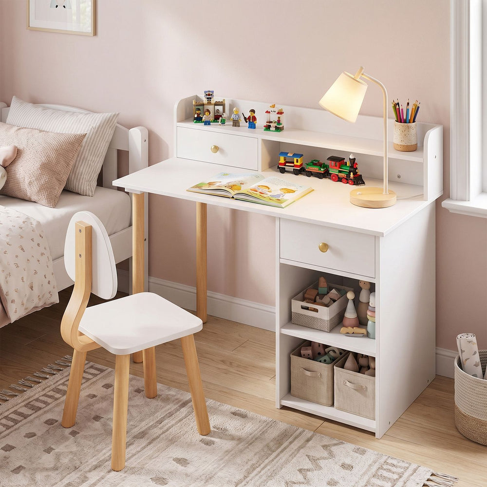 White wooden kids desk and chair set with hutch, drawer, and open shelves in a bedroom study nook.