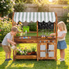 Wooden kids mud kitchen in brown with 4 stoves, chalkboard, and accessories for imaginative outdoor play.