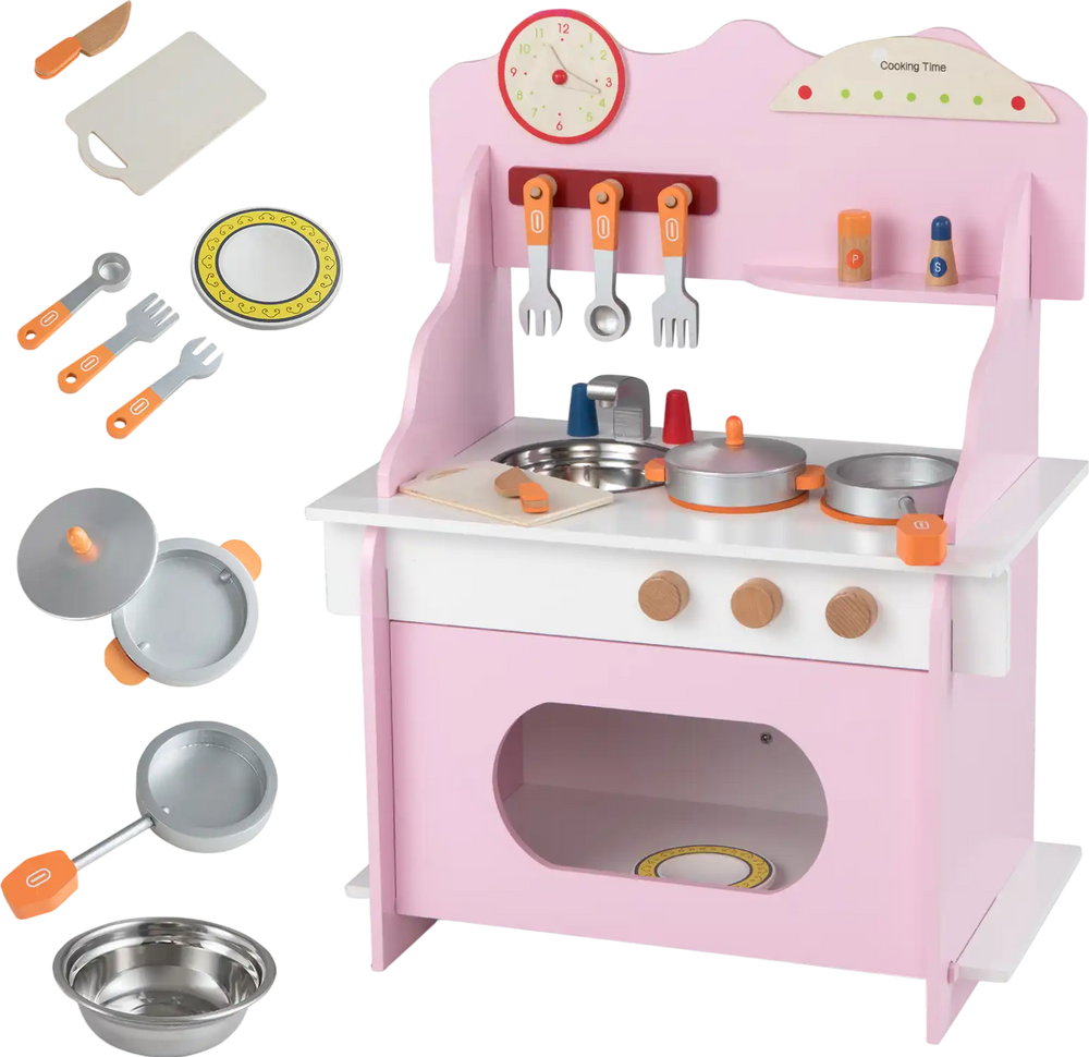 Wooden play kitchen set in pink with accessories, clock, and storage for imaginative pretend play for kids aged 3+.