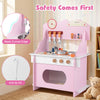 Wooden play kitchen set in pink with clock, sleek curved edges, and anti-tip kit for safe pretend play for kids.