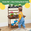 Wooden potting bench table for kids with rounded corners, removable sink, and ample storage for creative gardening play.