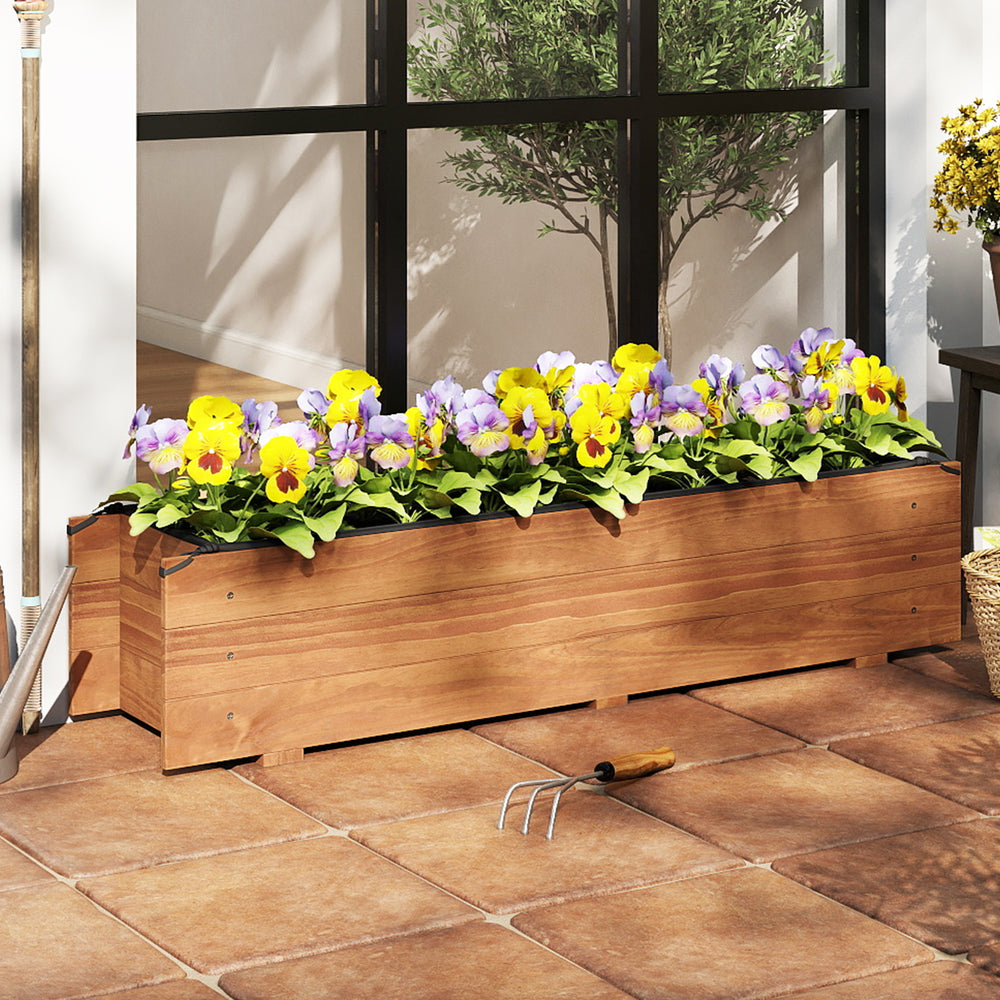 Wooden raised garden bed in orange with vibrant flowers, ideal for patios and balconies, featuring drainage holes and.