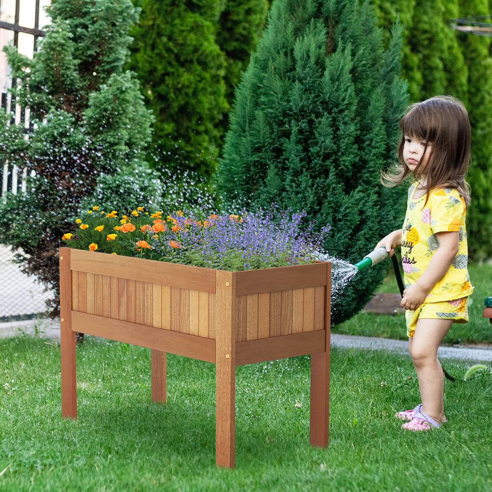 Wooden raised garden bed with legs, crafted from solid wood, perfect for outdoor planting and keeping plants safe from.