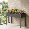 Elevated gray wooden vegetable planter with vibrant flowers, ideal for gardens and patios, 30" height for easy access.