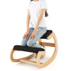 Wooden rocking chair with black padded seat cushion, designed for posture improvement and comfort during work or.