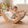 Wooden rocking climbing arch with cushion for kids, featuring a multicolor design, ideal for play and development.