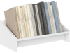 Small white wooden tilting bookcase displaying organized books, ideal for desktop use and space-saving storage.