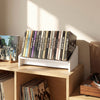 White wooden tilting bookshelf organizer displaying vinyl records, ideal for desktop use in living rooms or studies.