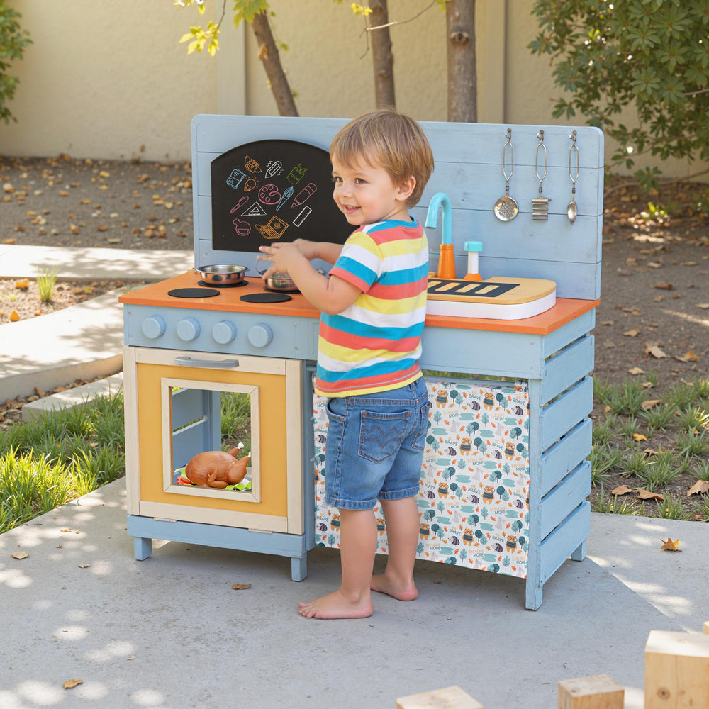 Wooden toy kitchen playset in blue with removable faucet, stovetops, and storage, perfect for outdoor imaginative play.