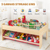 Wooden train set table with reversible tabletops and 3 fabric storage bins for organizing toys and accessories.