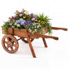 Wooden wagon planter with wheels featuring a large slatted box, perfect for displaying flowers and herbs indoors or outdoors.