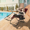 Dark red outdoor folding zero gravity reclining lounge chair by the pool, featuring a removable headrest and cup holder.