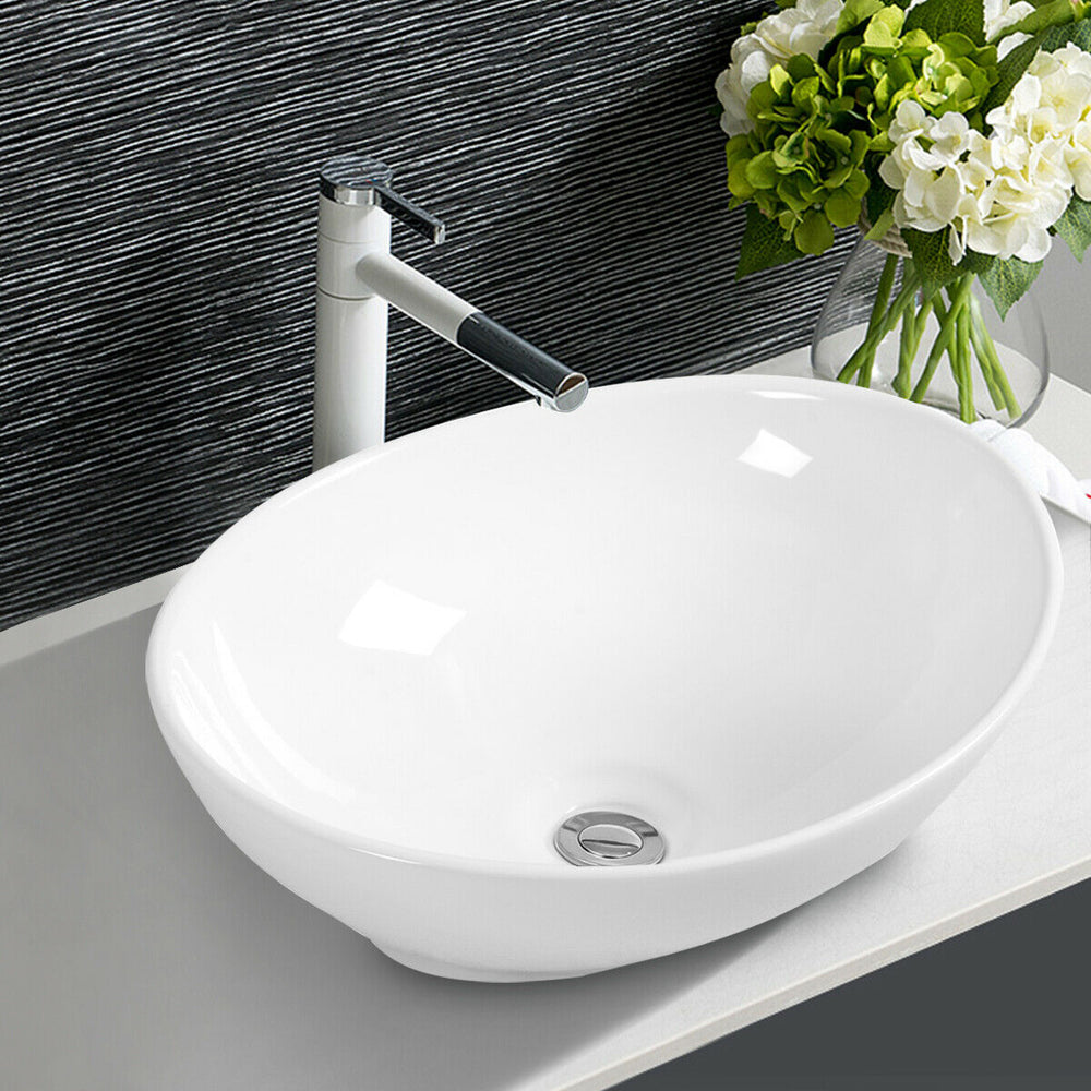 Oval ceramic vessel sink with popup drain design, perfect for modern bathroom upgrades and aesthetic appeal.