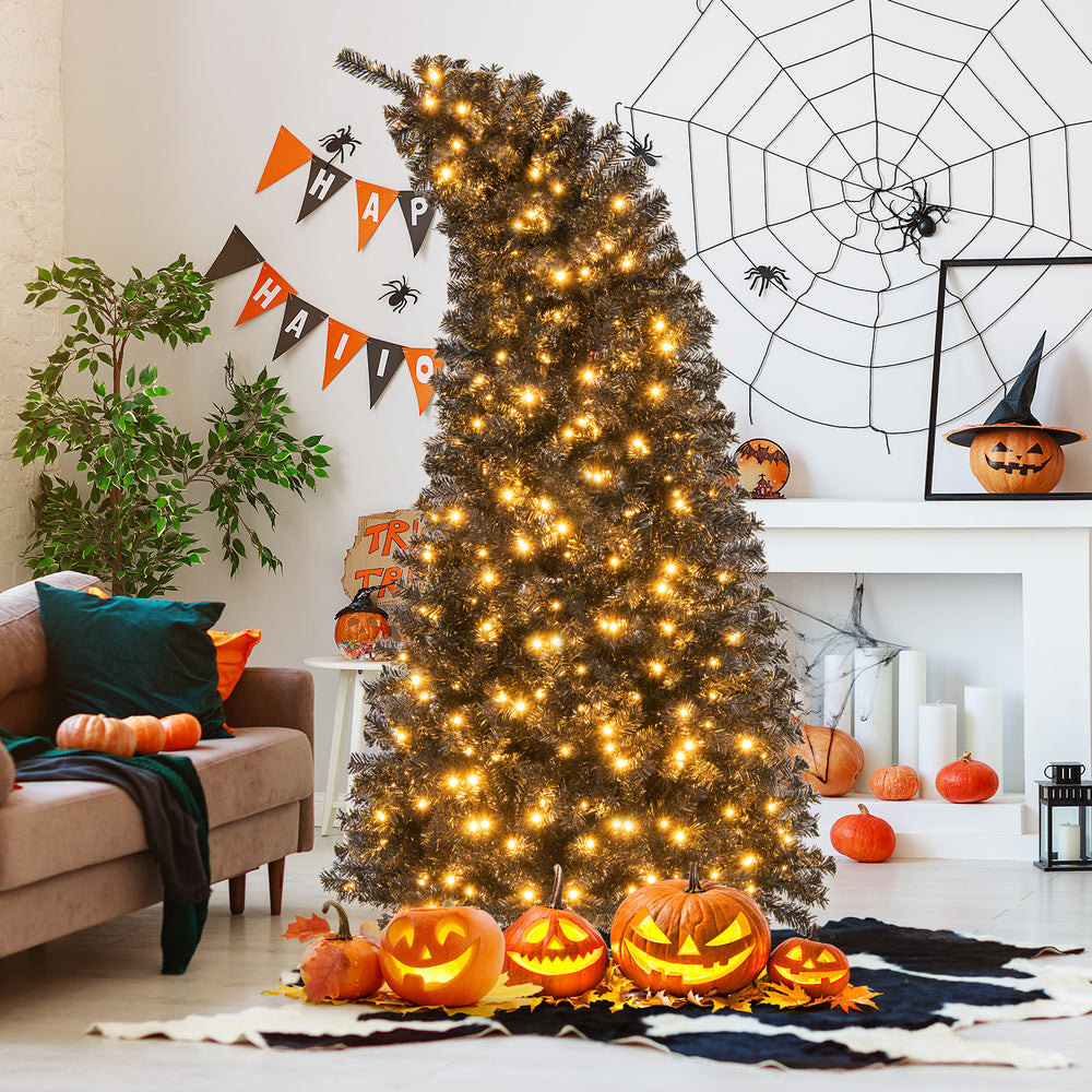 7 ft artificial Christmas tree with bendable top and dense black leaves, beautifully illuminated with warm LED lights.