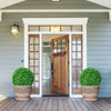 Two 19.5-inch faux boxwood topiary balls in decorative pots, enhancing the entrance with vibrant greenery.